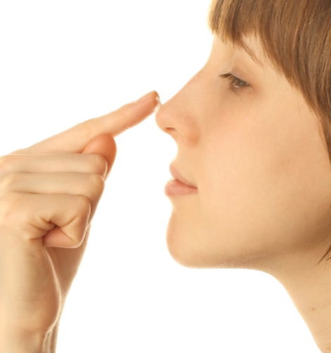 Young woman with cream on nose