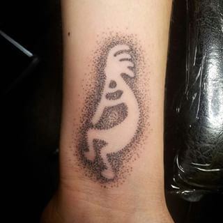 Dot work Kokopelli tattoo